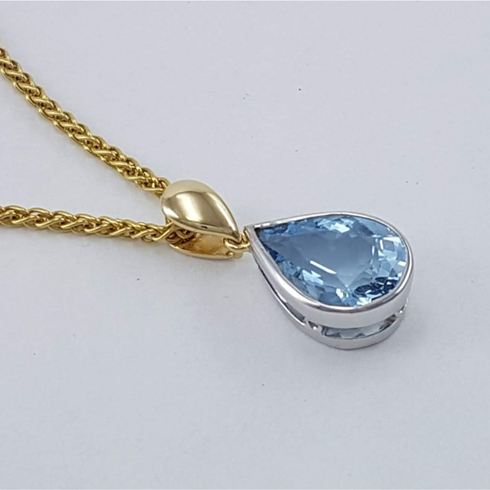 White and Yellow Gold rubbed in set Pear cut Blue Topaz Pendant