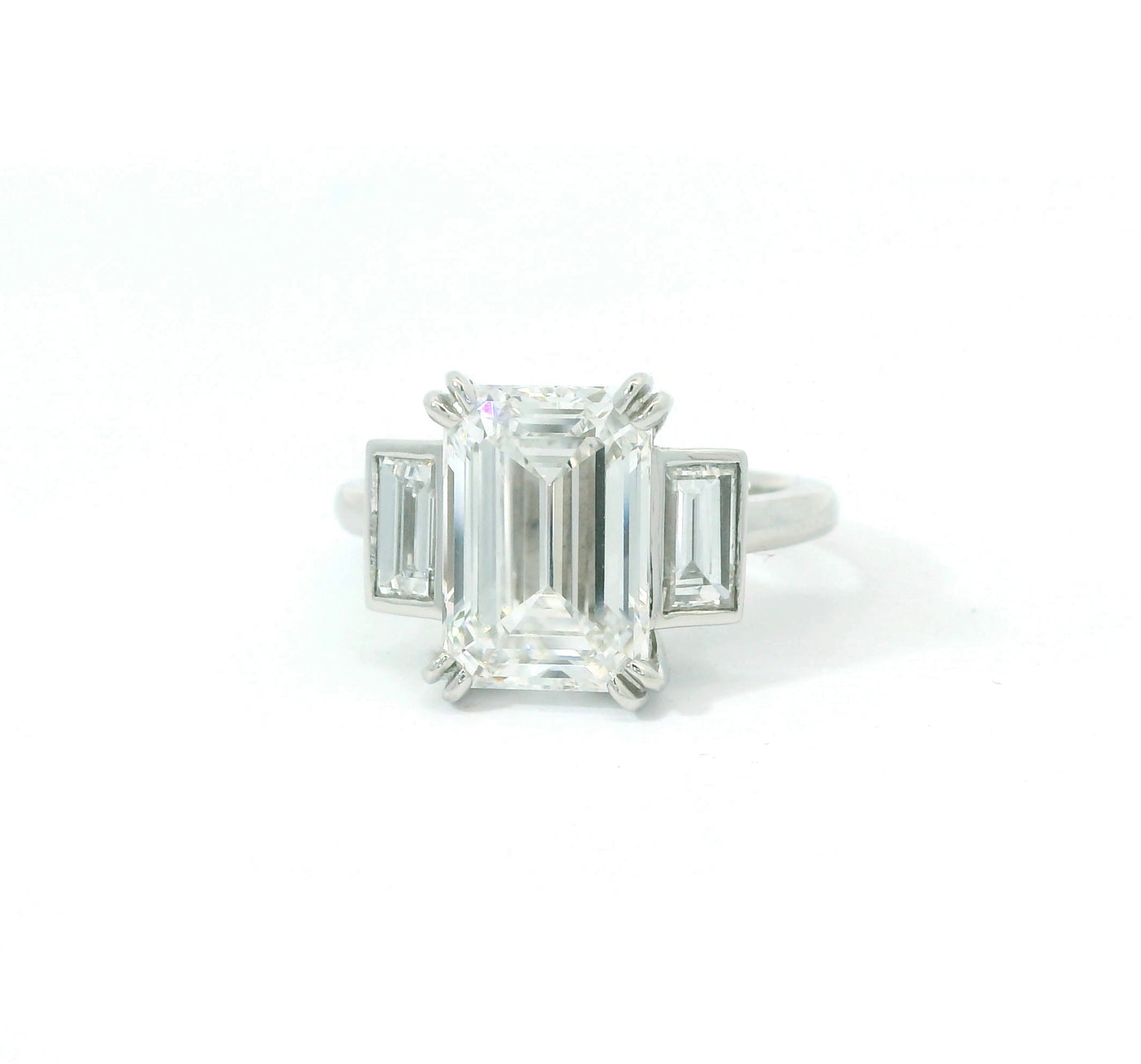 Platinum set Emerald cut Diamond Trilogy Ring.
