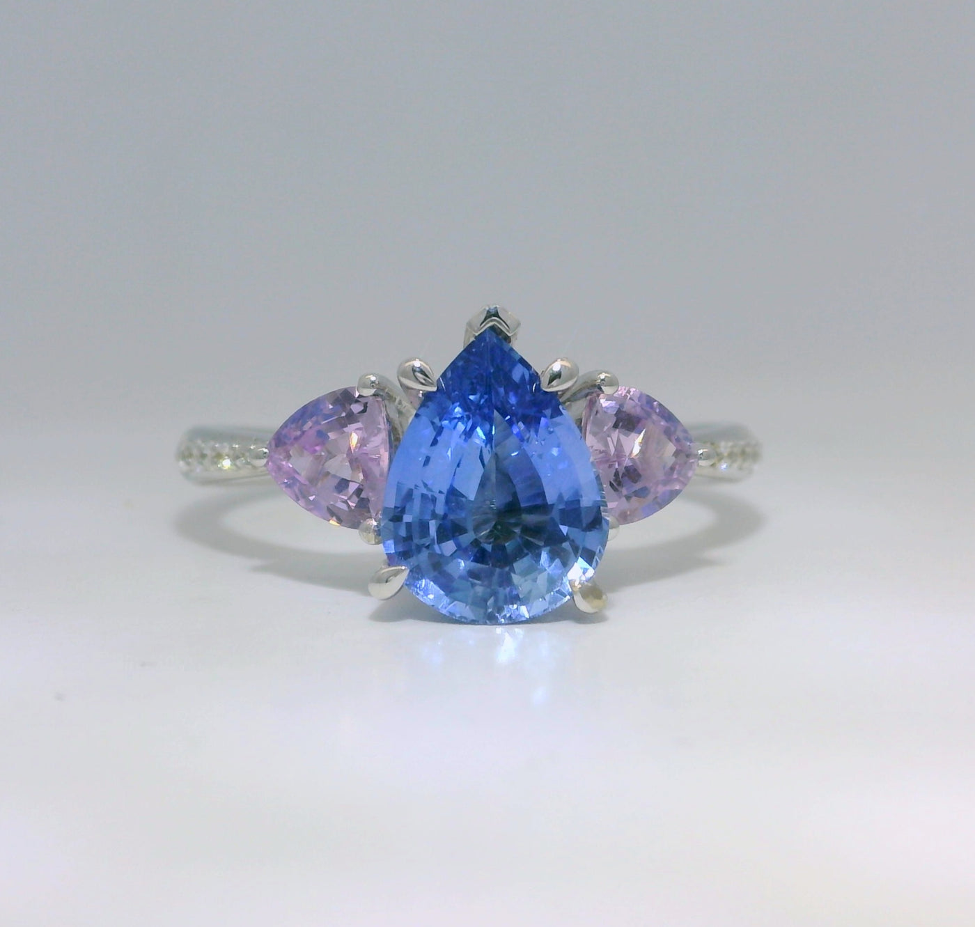 18ct White Gold Pear Cut Ceylon and Trilliant Lilac Sapphire Ring with grain set Diamond band
